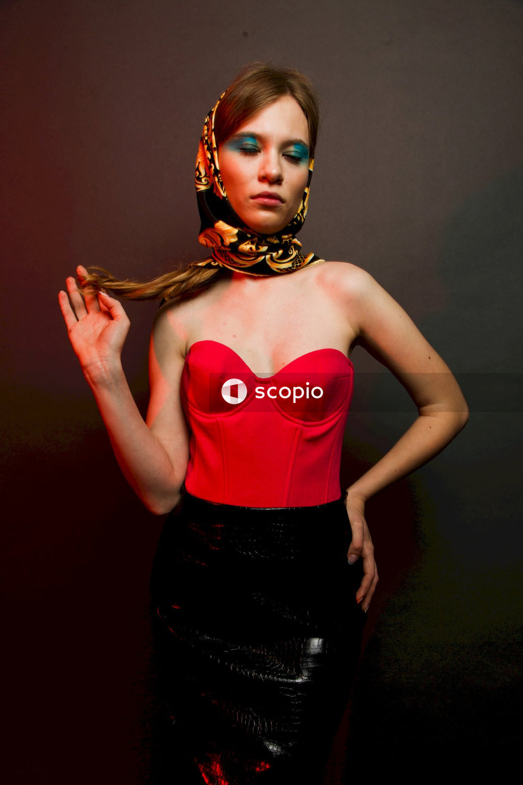 Woman in red spaghetti strap top and black skirt
