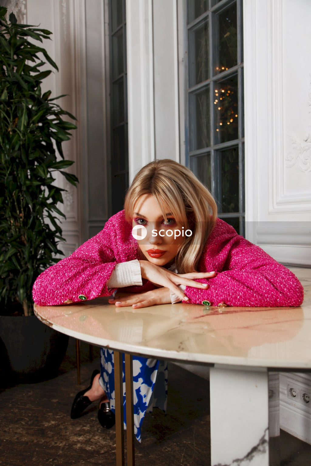 Woman in red sweater sitting on chair