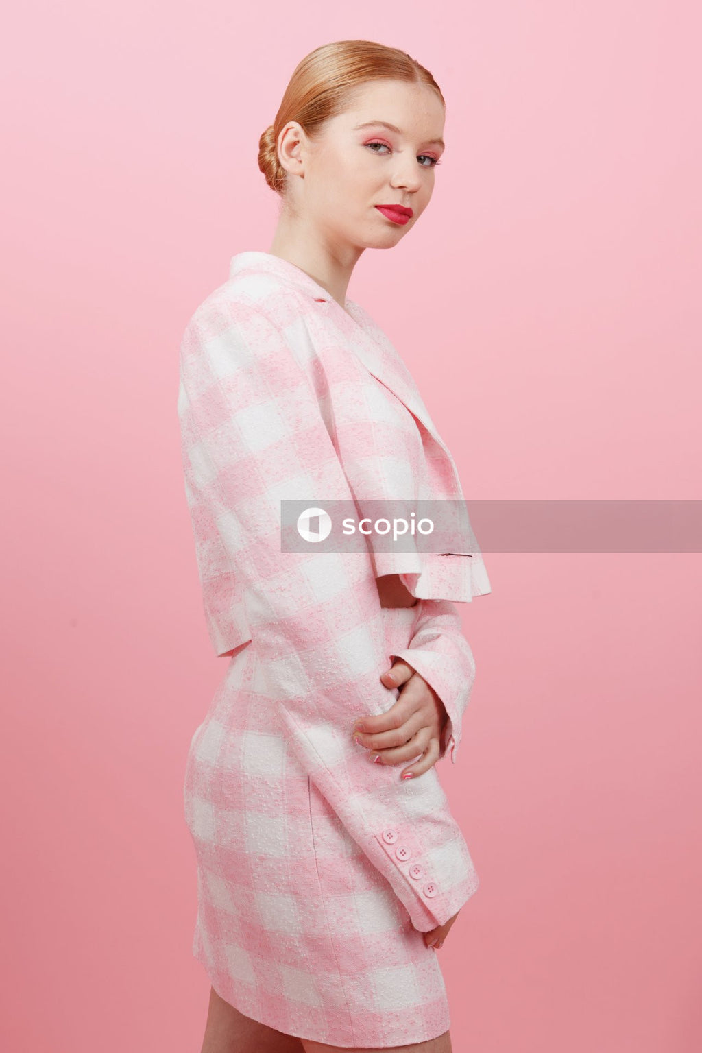 Woman in white and pink checkered robe