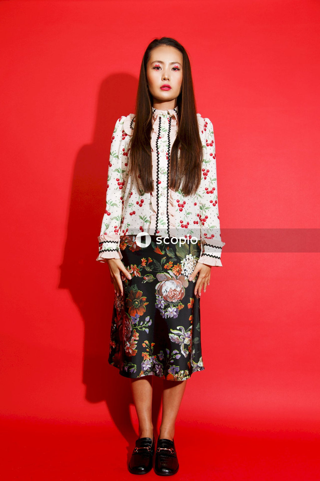 Woman in white and pink floral long sleeve dress