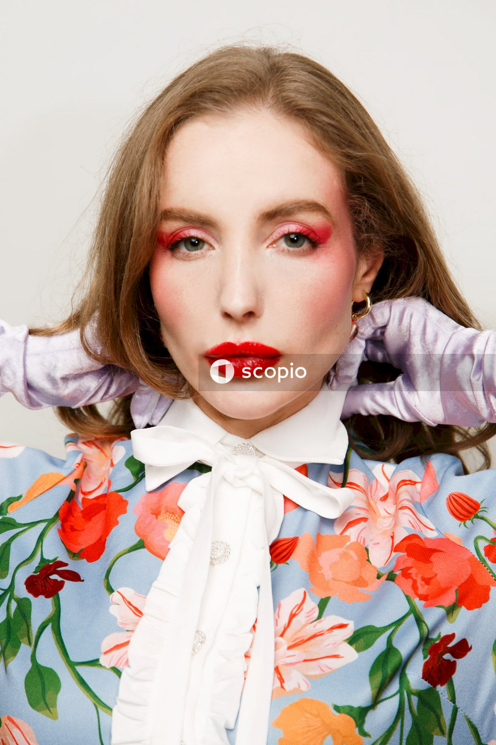 Woman in white and red floral dress shirt