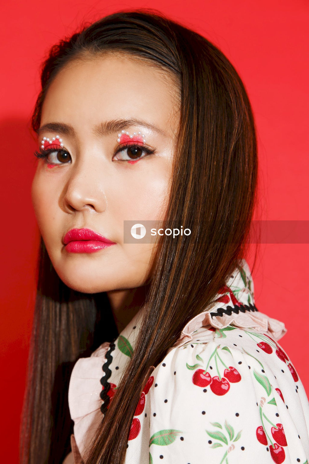 Woman in white and red floral scarf