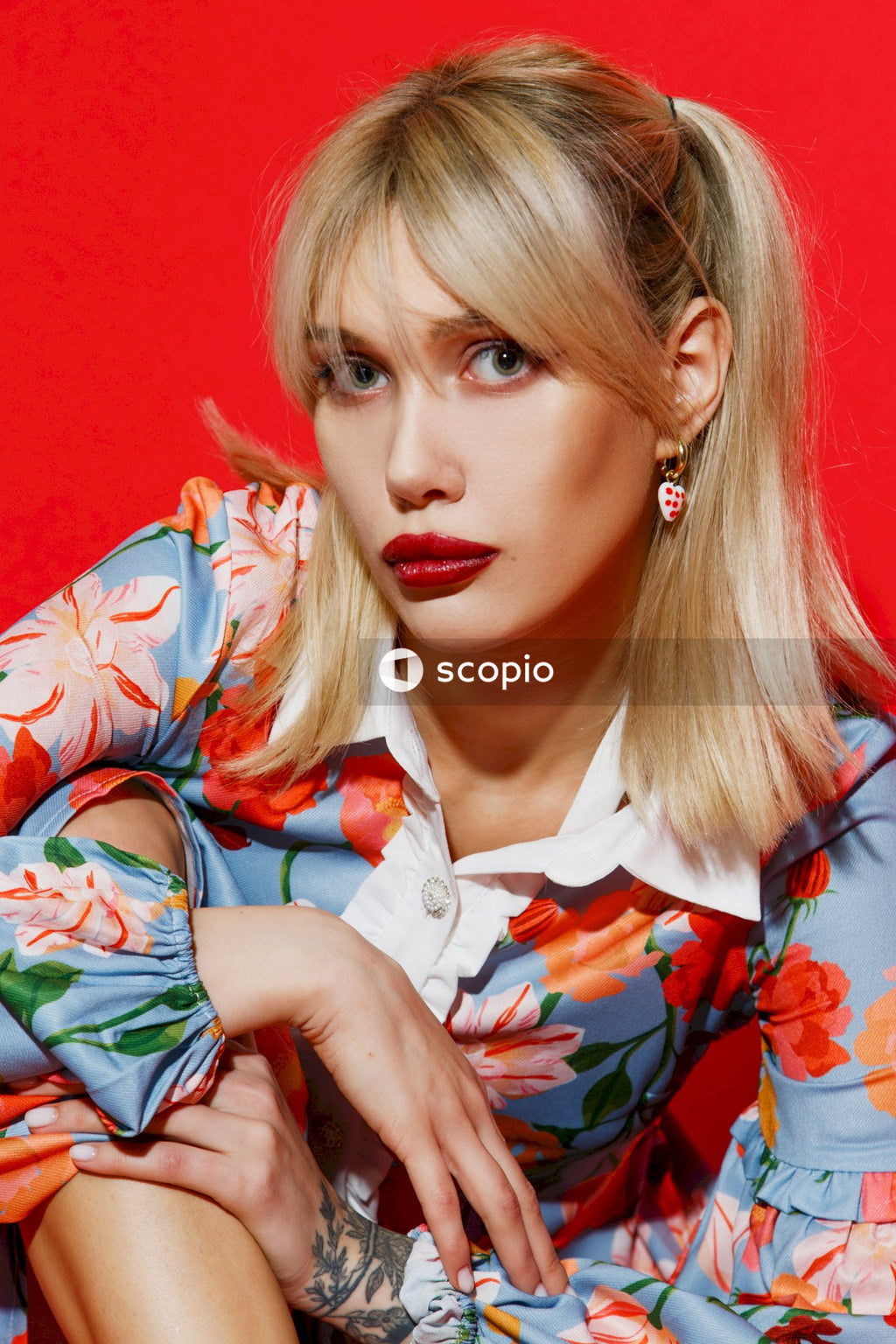 Woman in white blue and red floral button up shirt