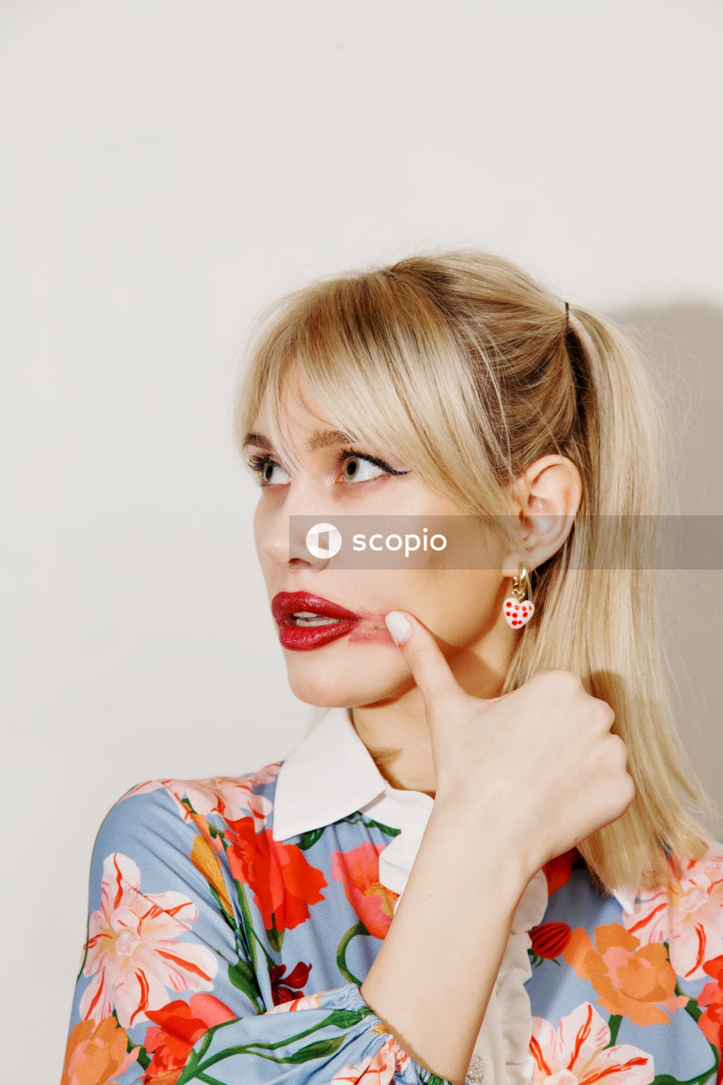 Woman in white blue and red floral shirt