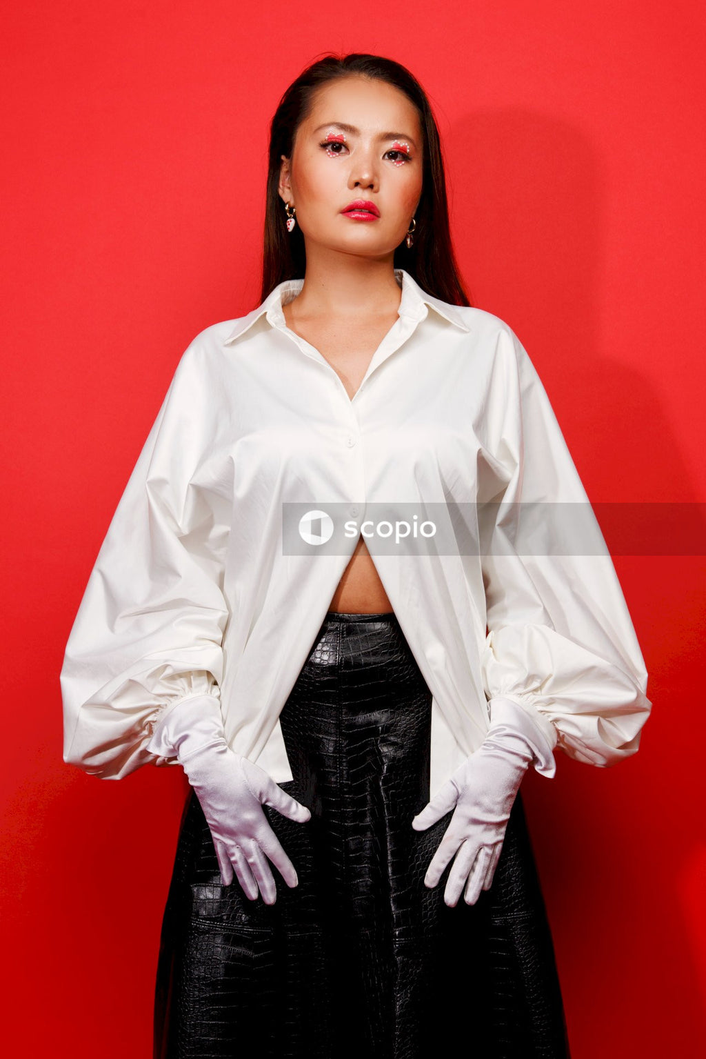 Woman in white button up long sleeve shirt and black skirt