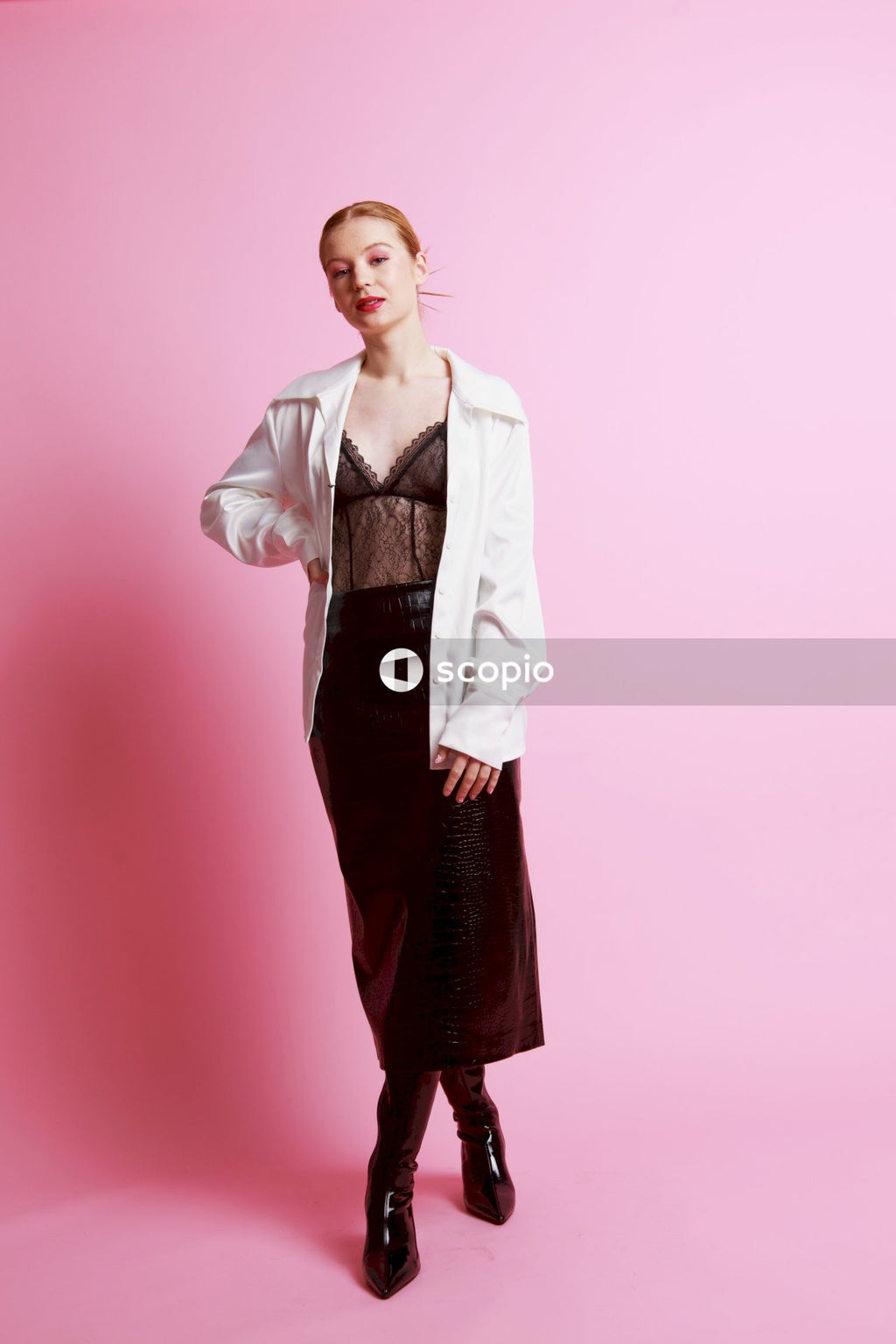 Woman in white button up shirt and red skirt