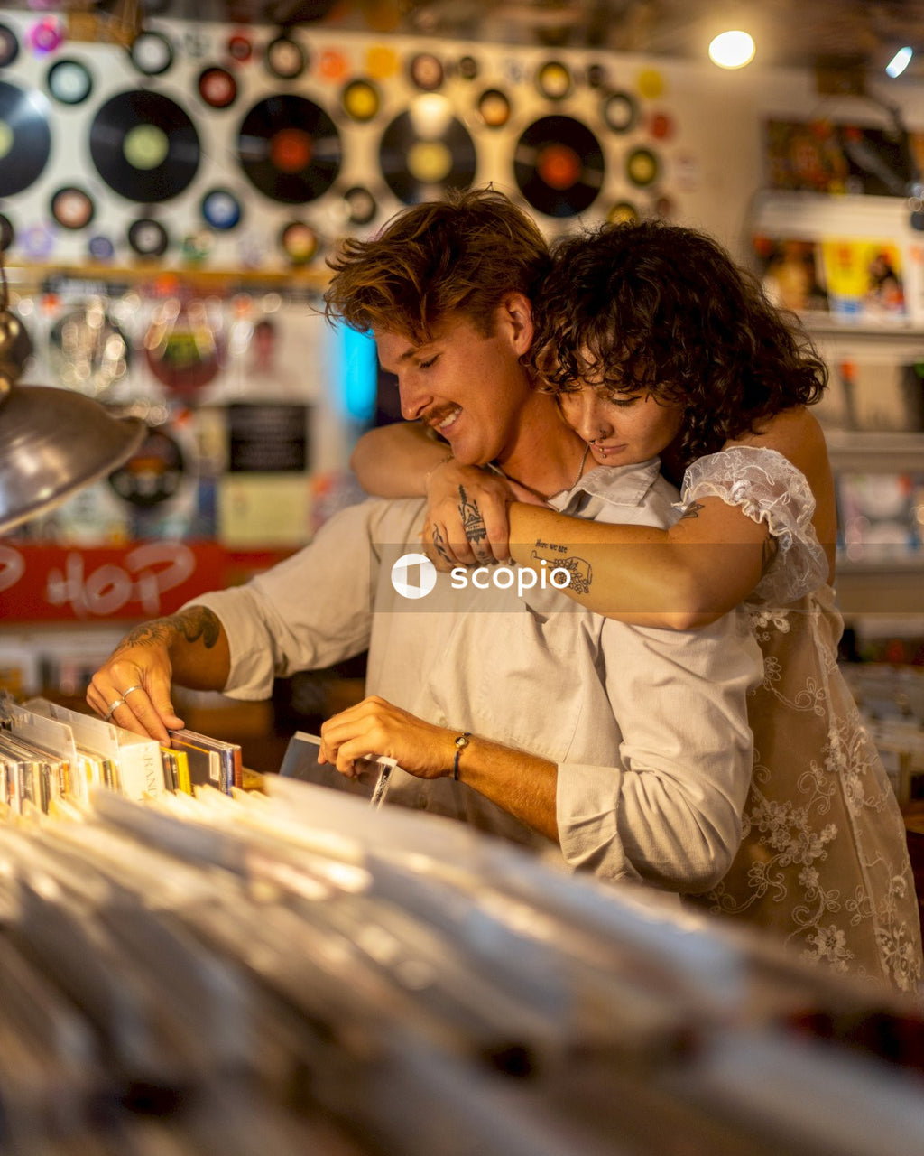 Woman in white dress hugging girl in white dress
