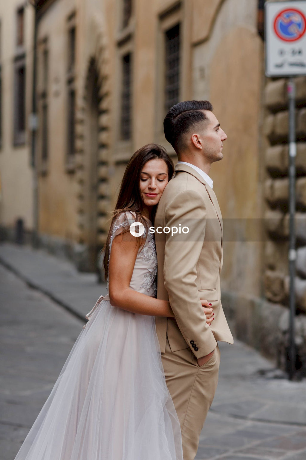 Woman in white dress hugging woman in white dress