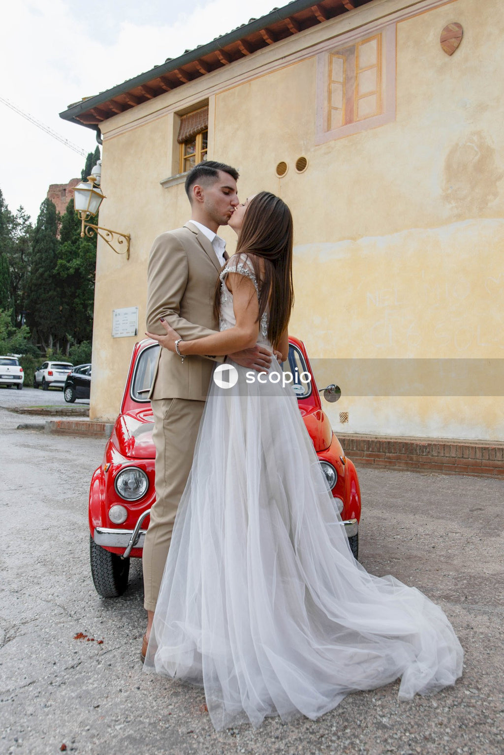 Woman in white dress hugging woman in white dress