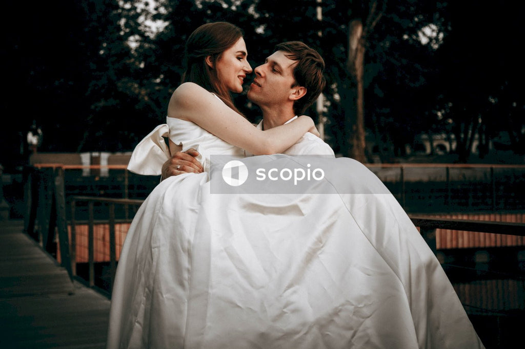 Woman in white dress hugging woman in white dress