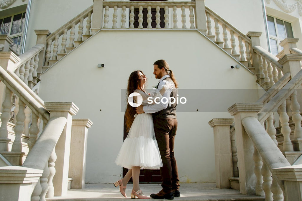 Woman in white dress hugging woman in white dress