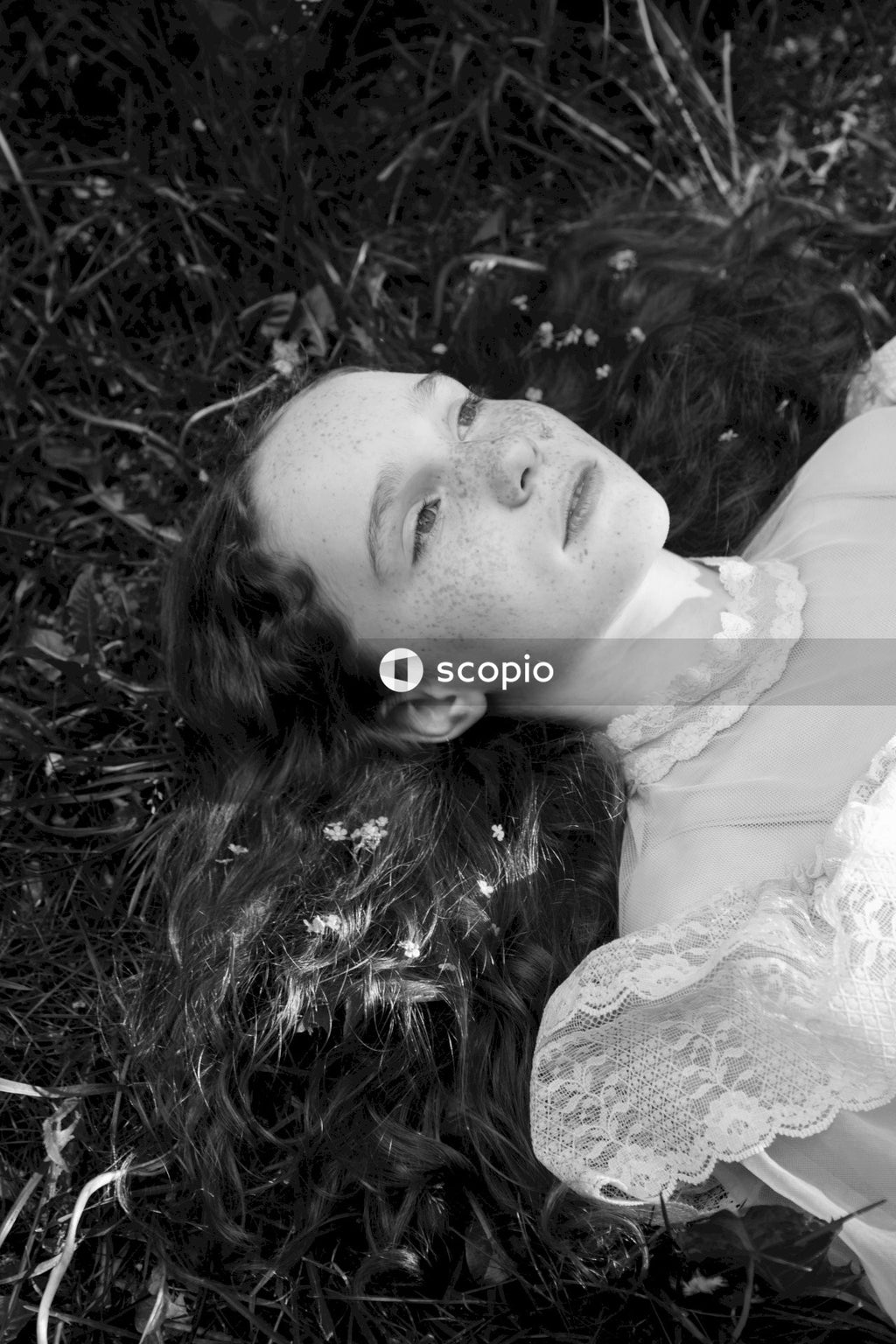 Woman in white dress lying on grass