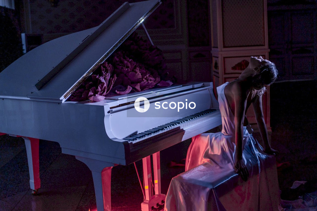 Woman in white dress playing grand piano