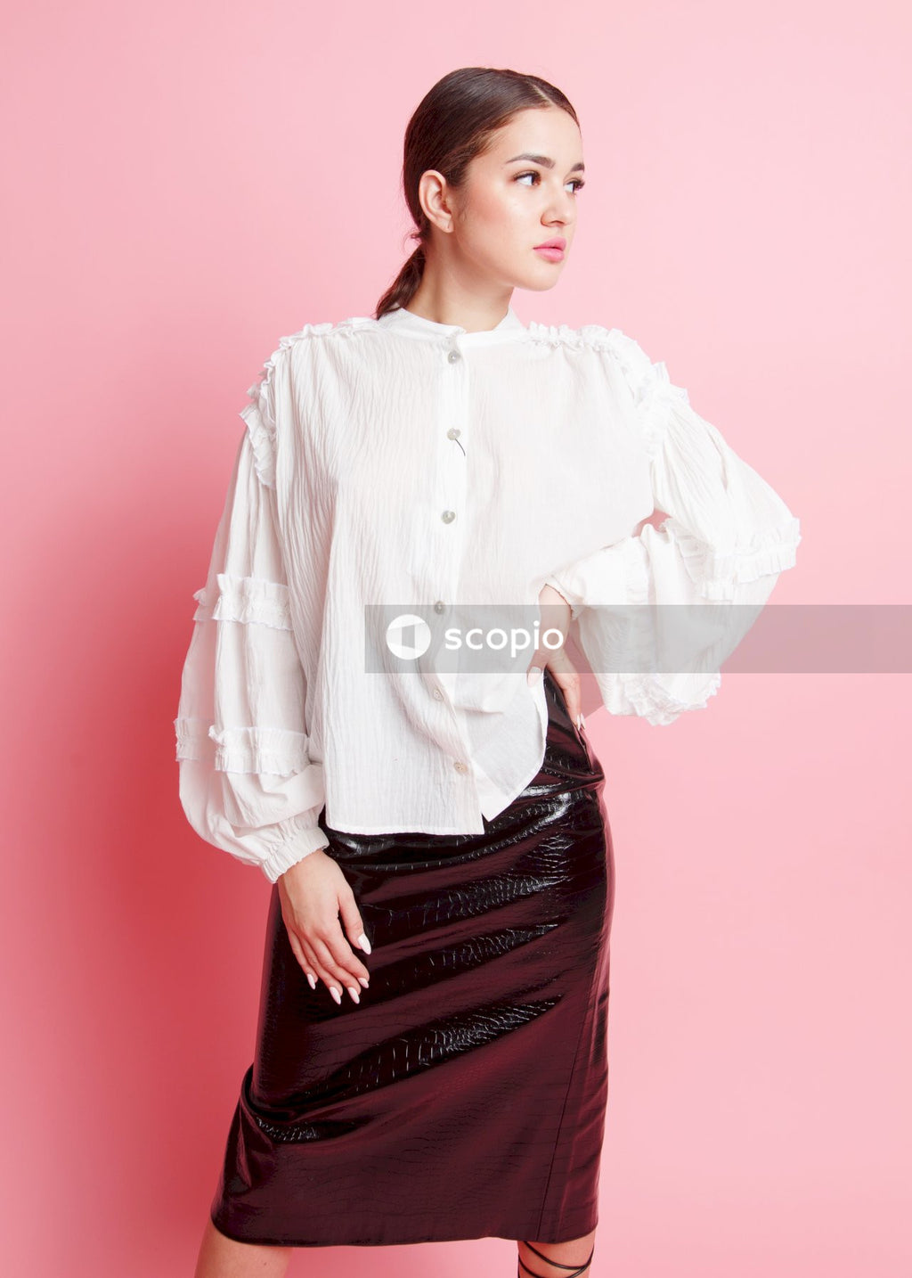 Woman in white dress shirt and black skirt