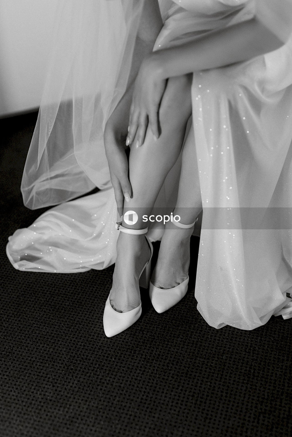 Woman in white dress sitting on black carpet