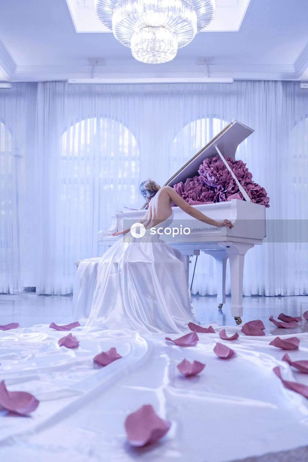 Woman in white dress sitting on white bench