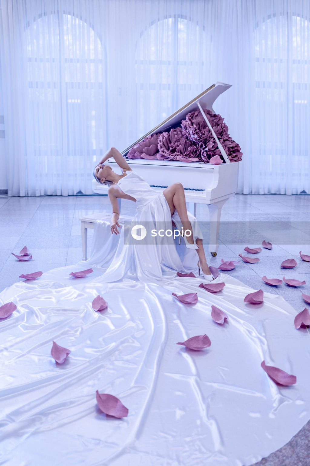 Woman in white dress sitting on white bench