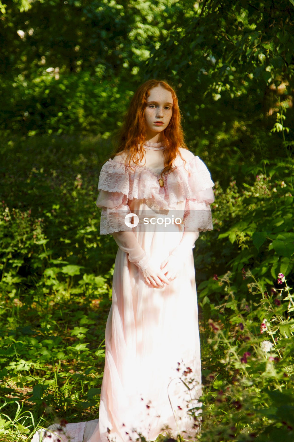 Woman in white dress standing on green grass field