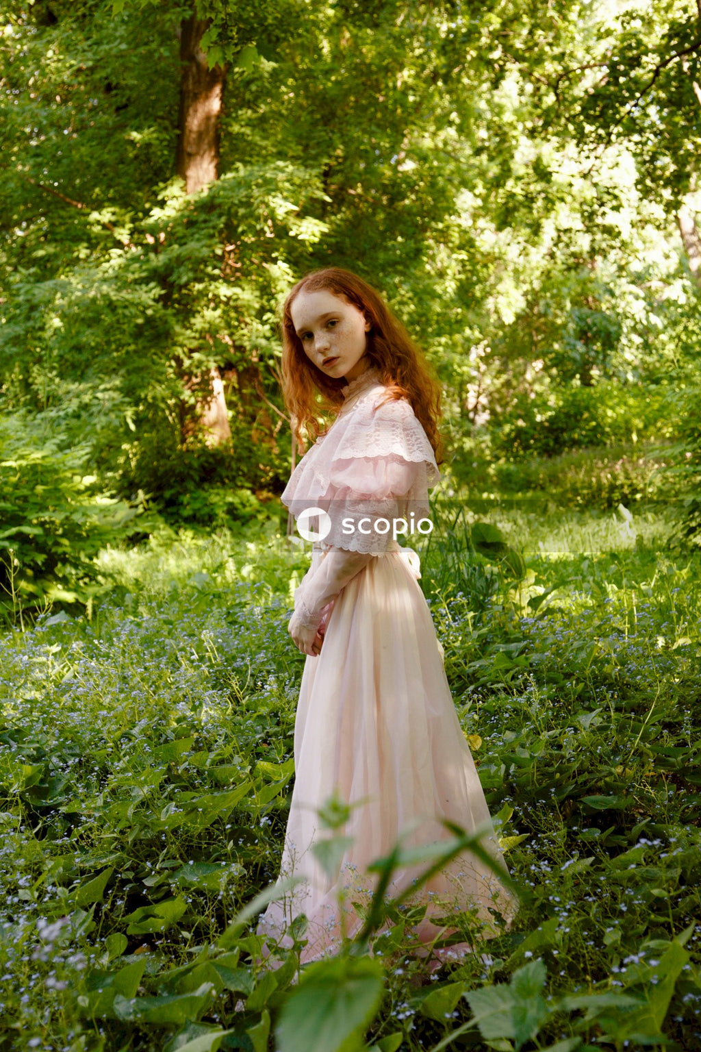 Woman in white dress standing on green grass field