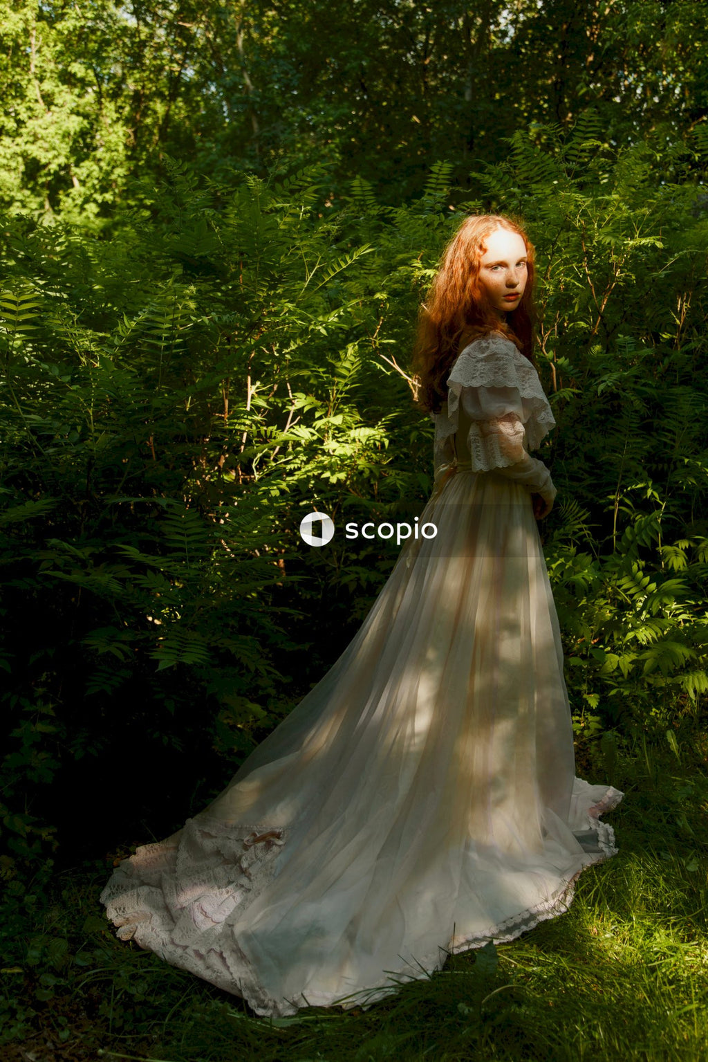 Woman in white dress standing on green grass field