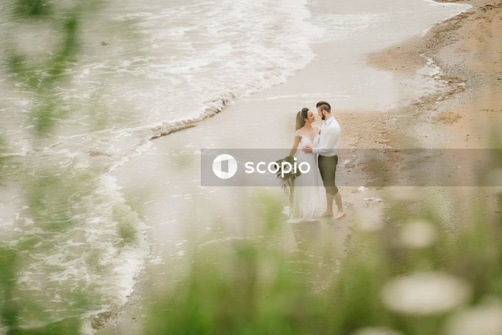 Woman in white dress walking on seashore