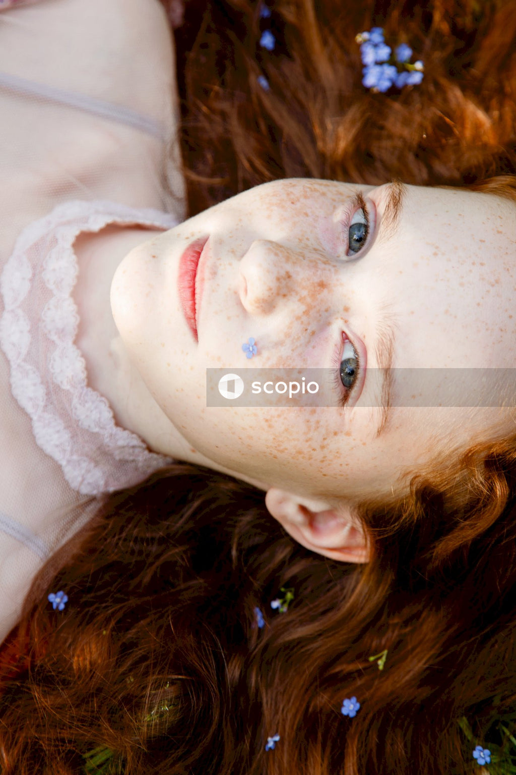 Woman in white floral lace shirt