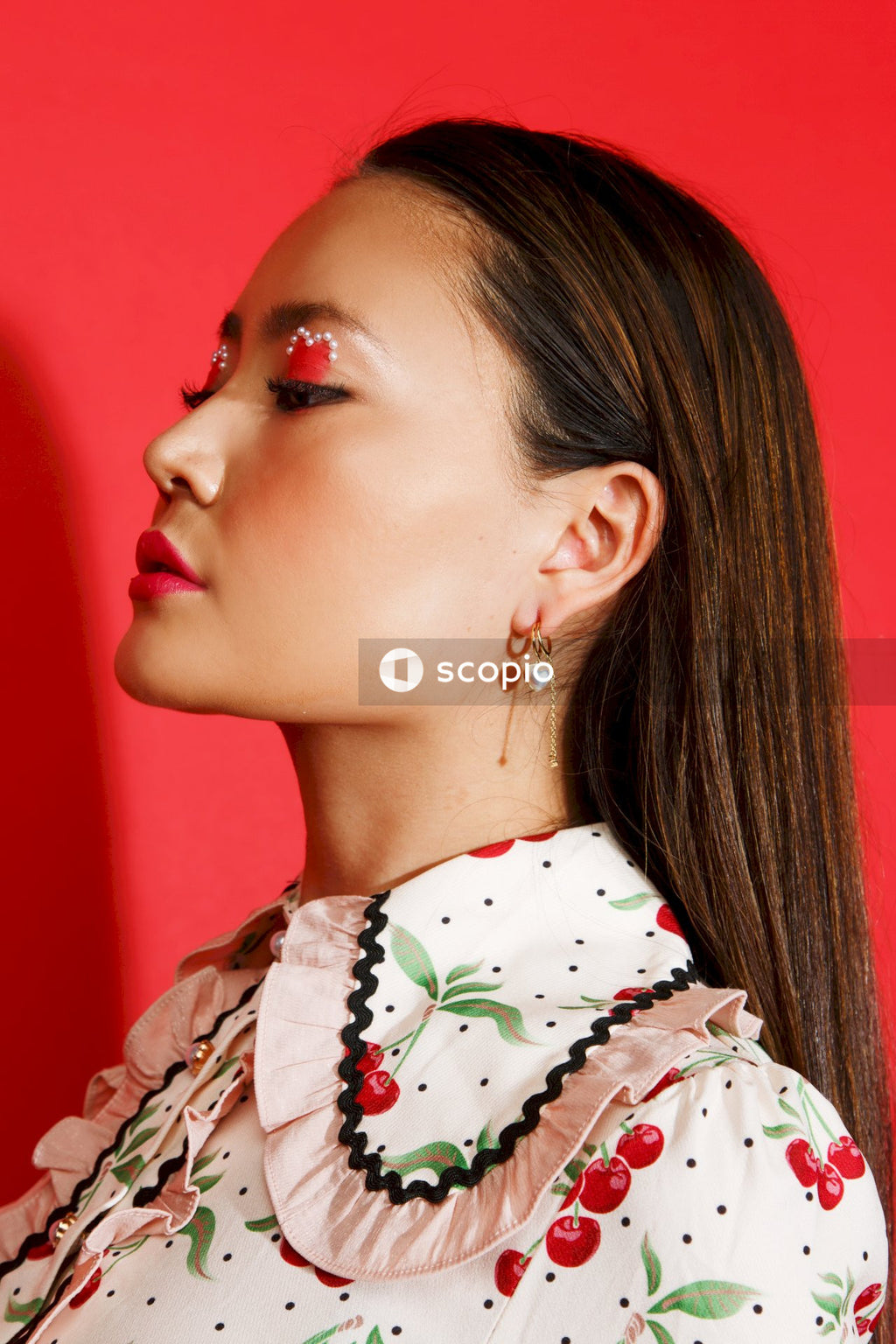 Woman in white green and red floral shirt