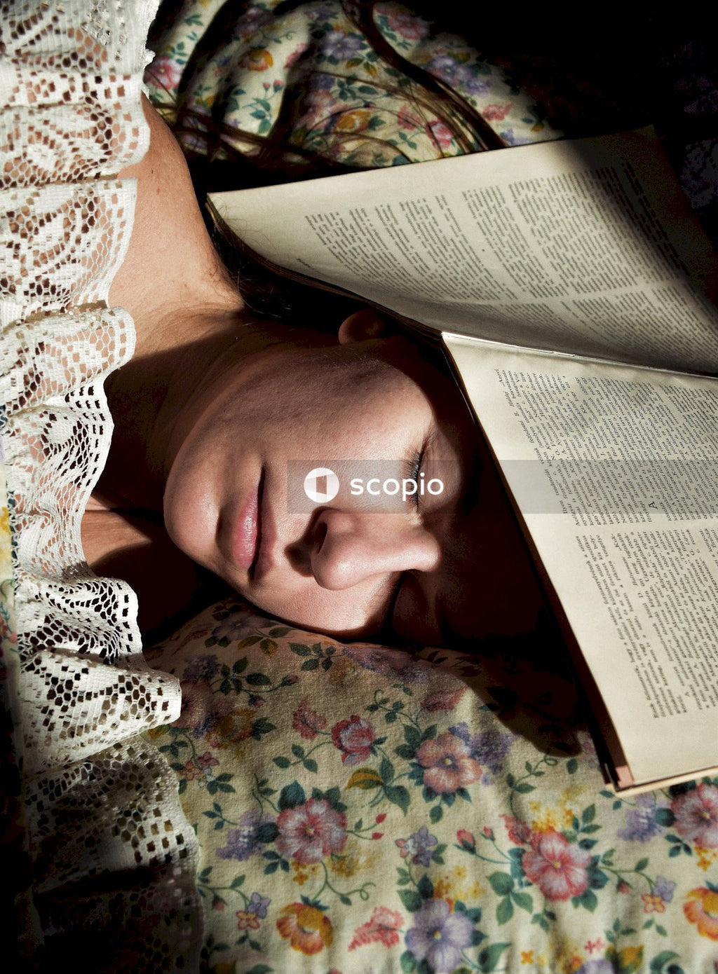 Woman in white knit shirt lying on bed