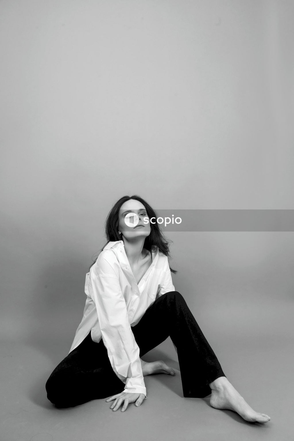 Woman in white long sleeve shirt and black pants