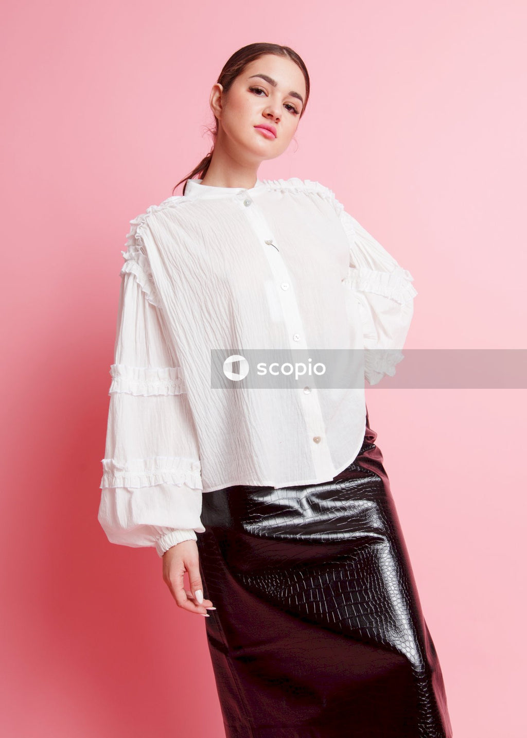 Woman in white long sleeve shirt and black skirt