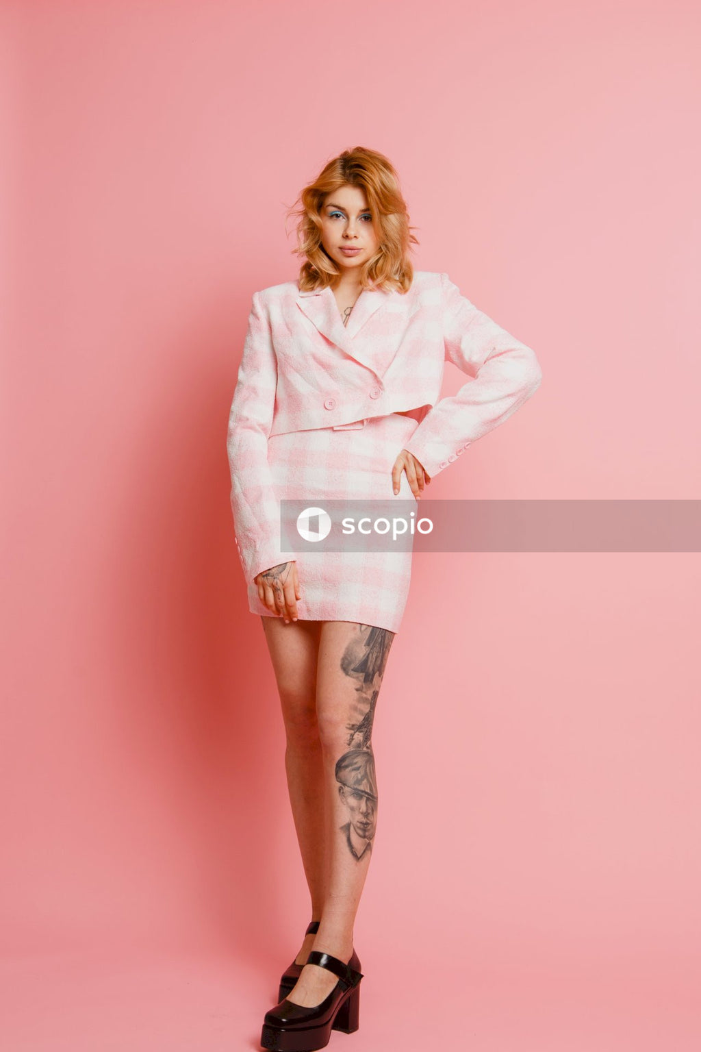 Woman in white long sleeve shirt and pink skirt