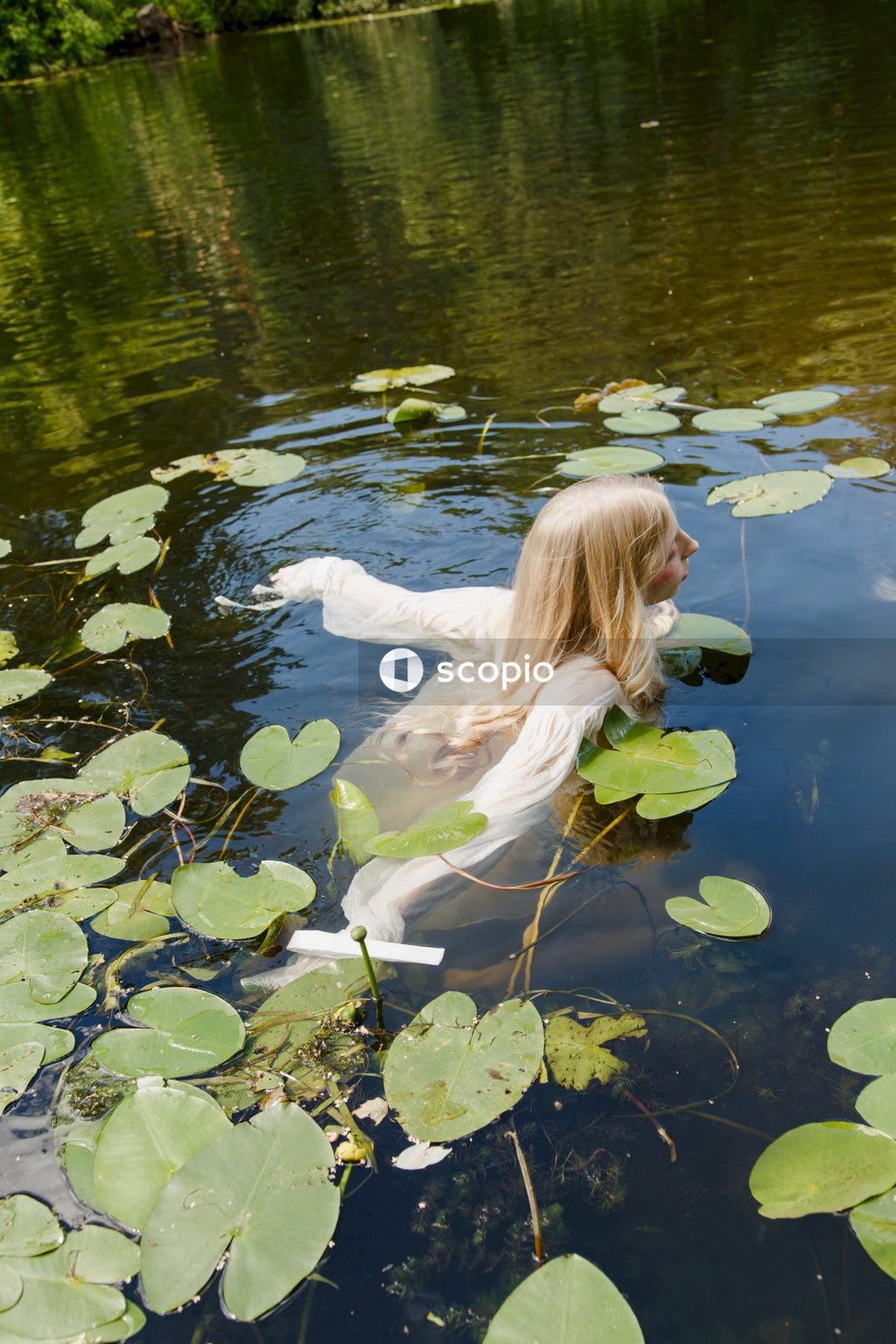 Woman in white long sleeve shirt on water