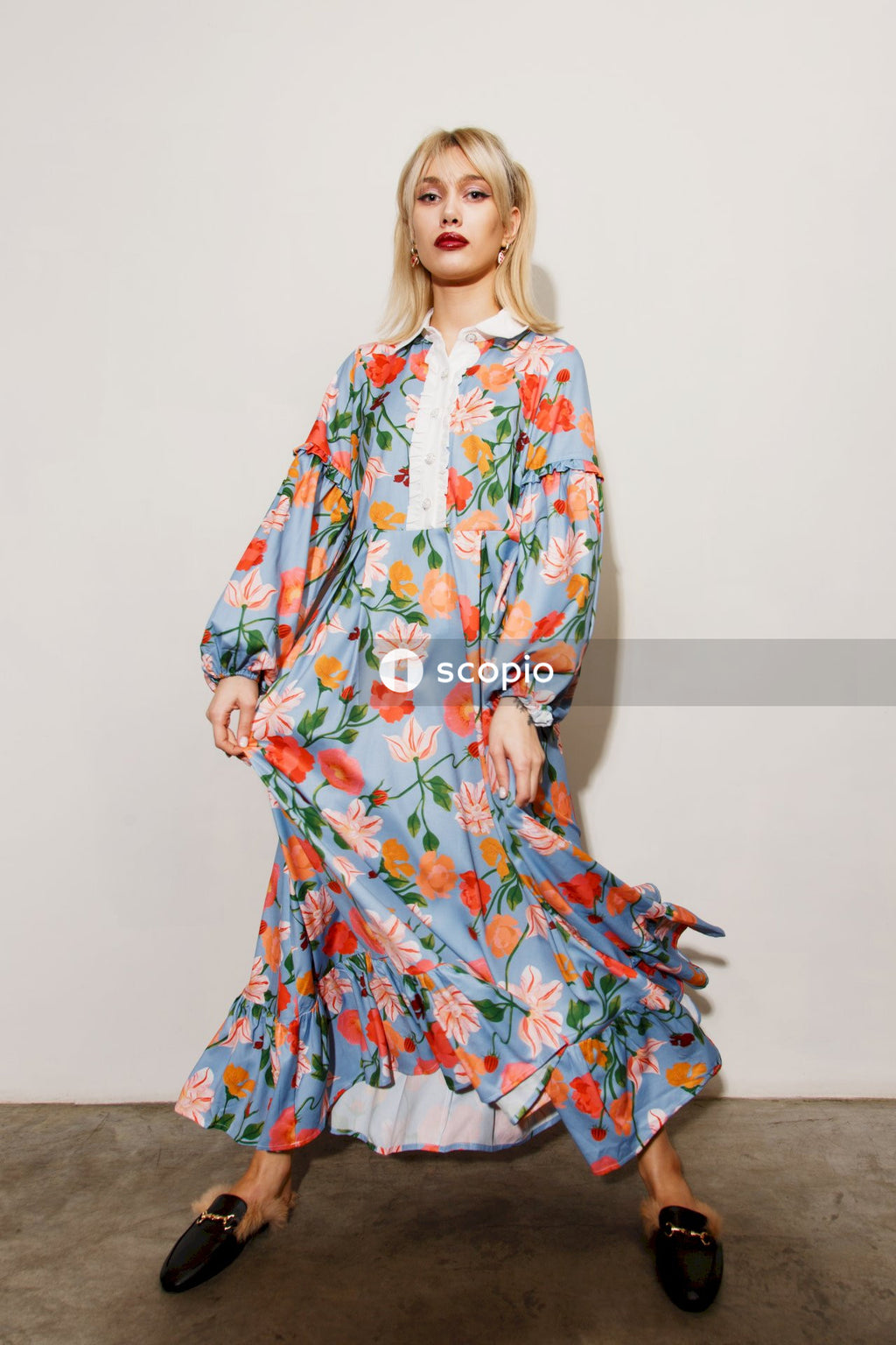 Woman in white red and blue floral long sleeve dress