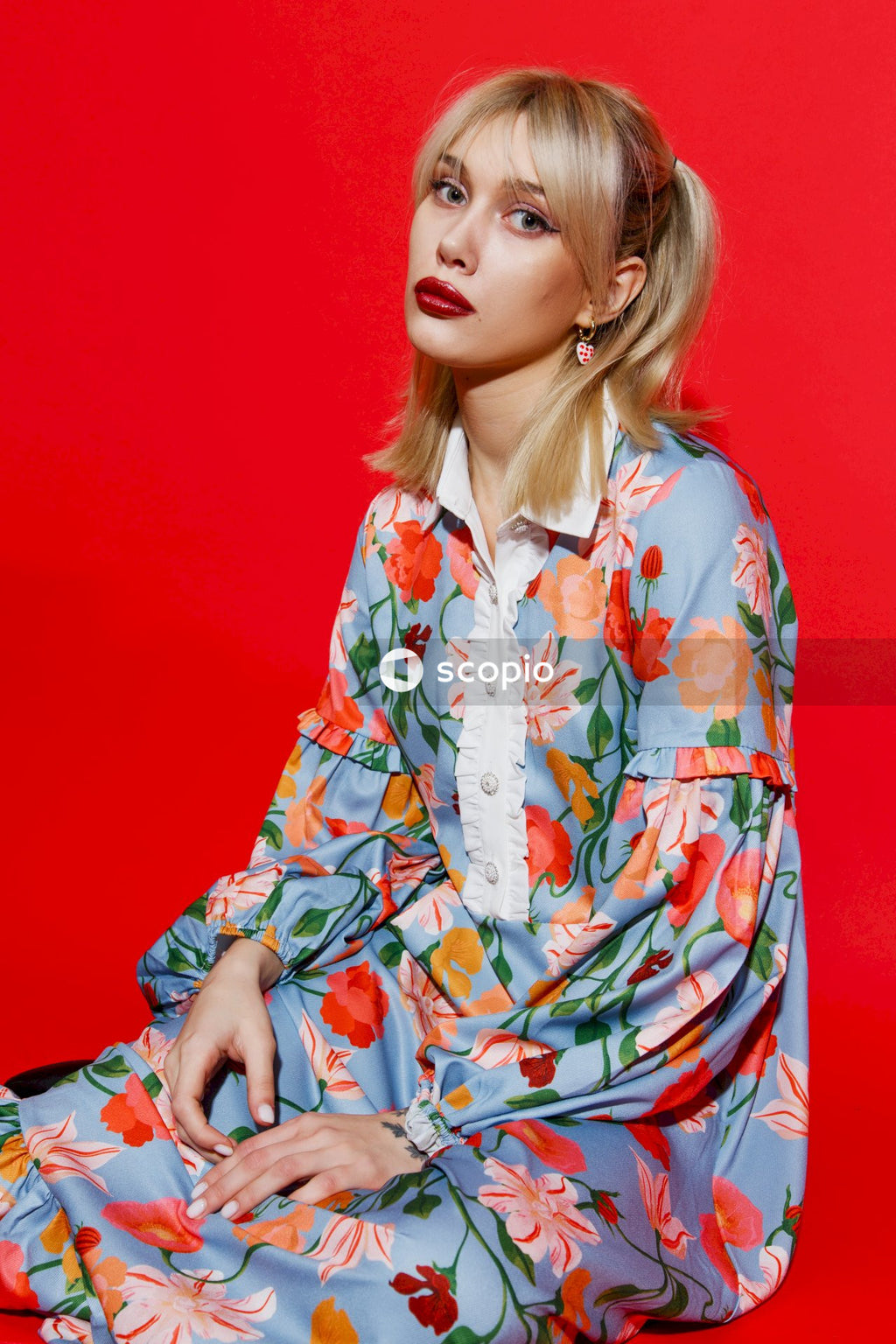 Woman in white red and blue floral long sleeve dress