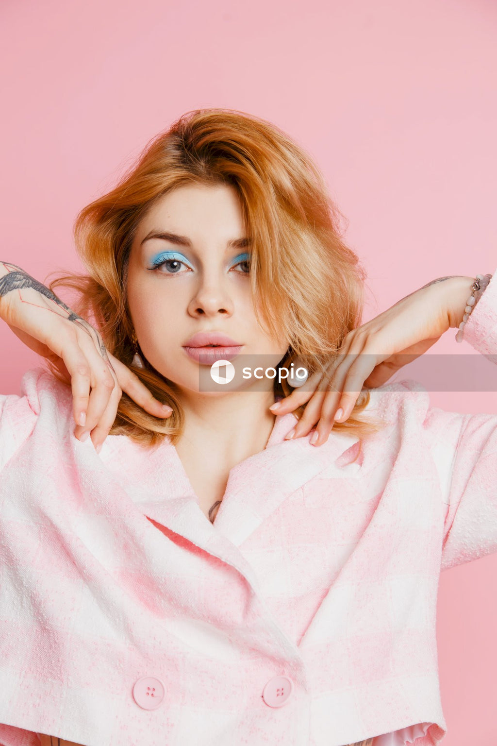 Woman in white robe holding her hair