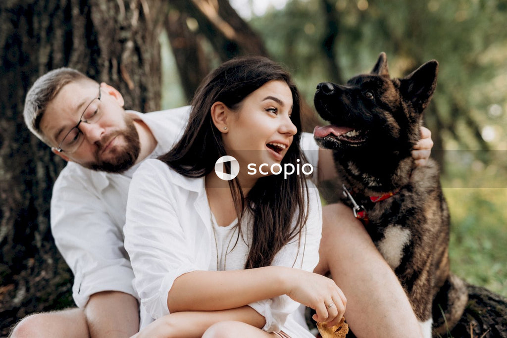 Woman in white shirt hugging german shepherd