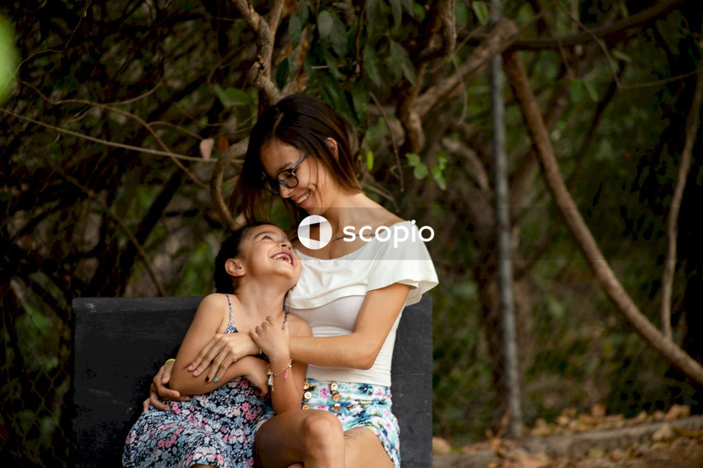 Woman in white shirt hugging woman in white shirt