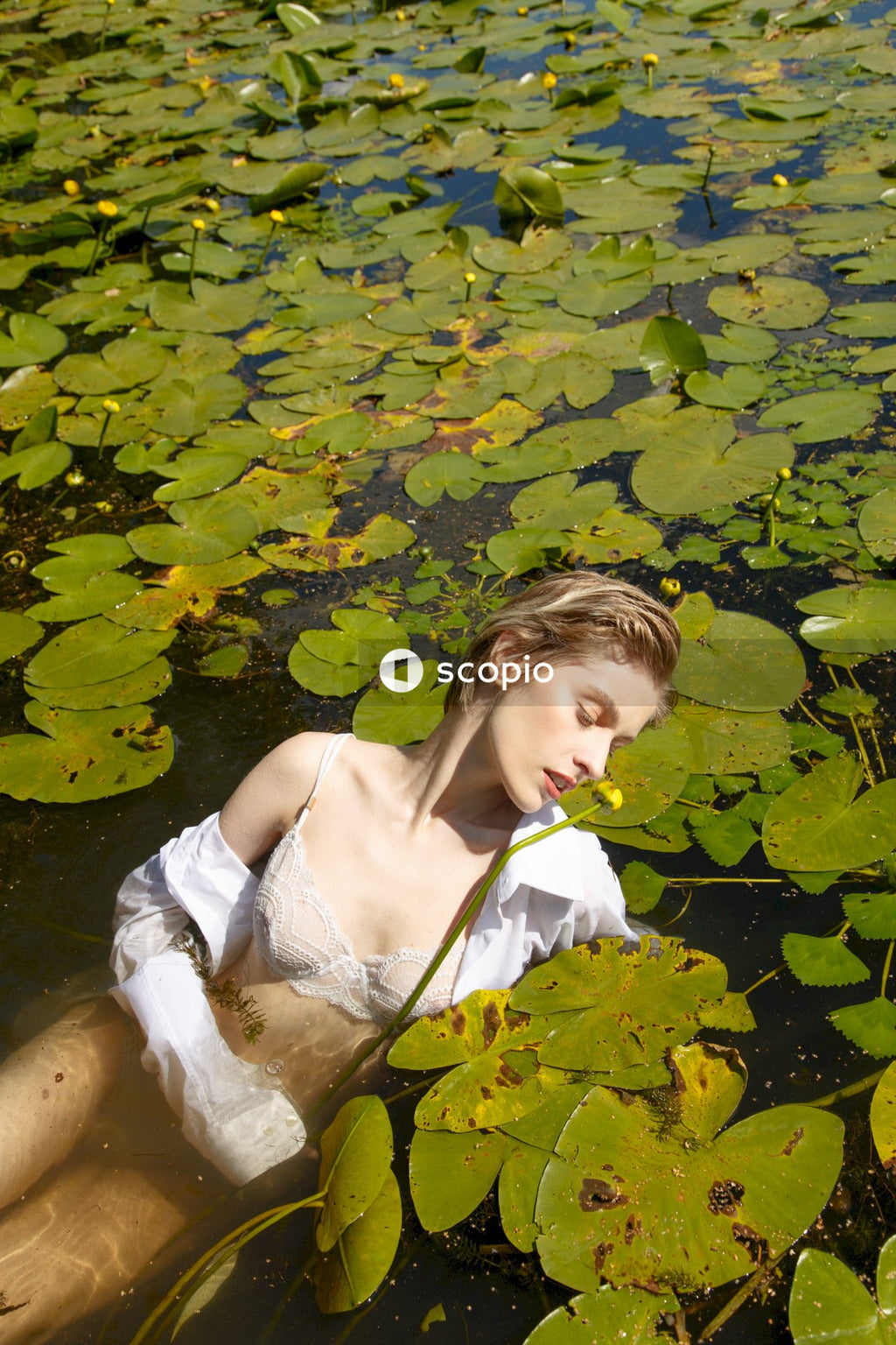 Woman in white spaghetti strap top on water