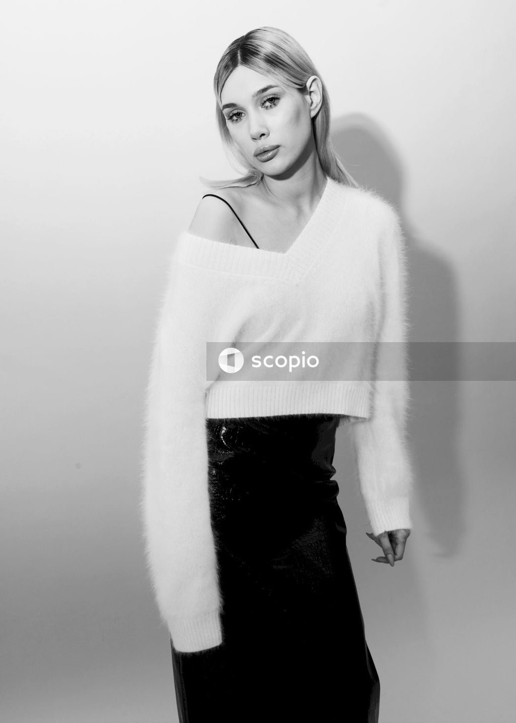 Woman in white sweater and black skirt