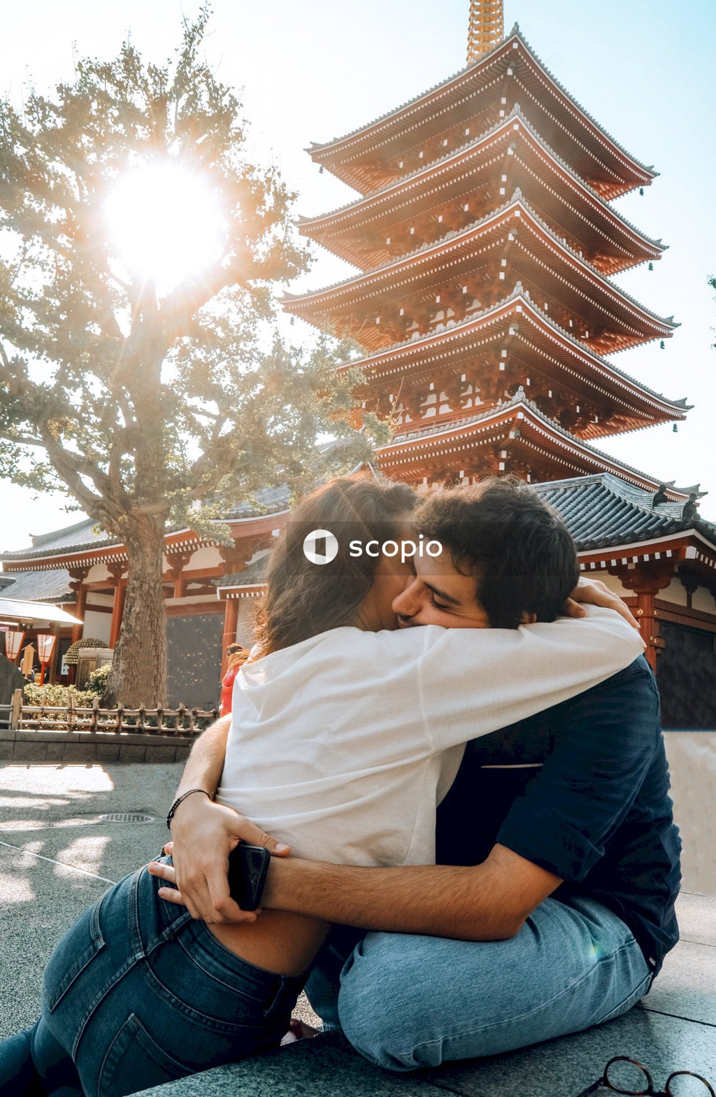 Man and woman hugging beside Sensō-ji temple in Asakusa, Japan