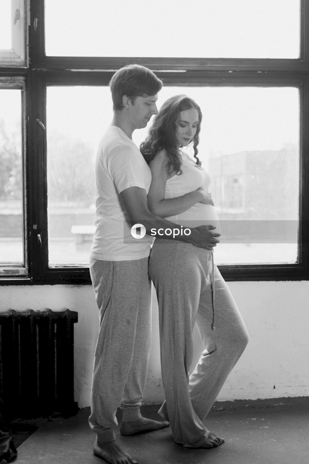 Man in white t-shirt hugging woman