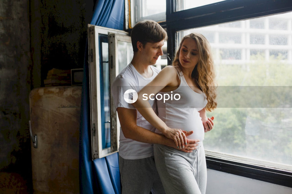 Couple standing next to glass window