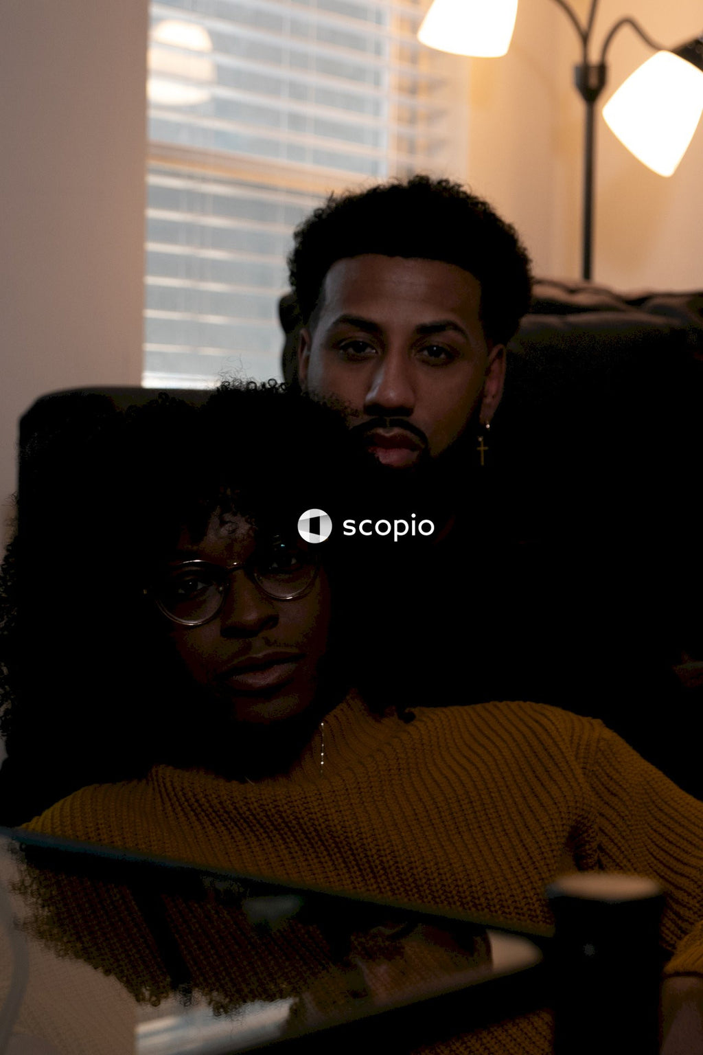 Couple sitting on the ground in living room