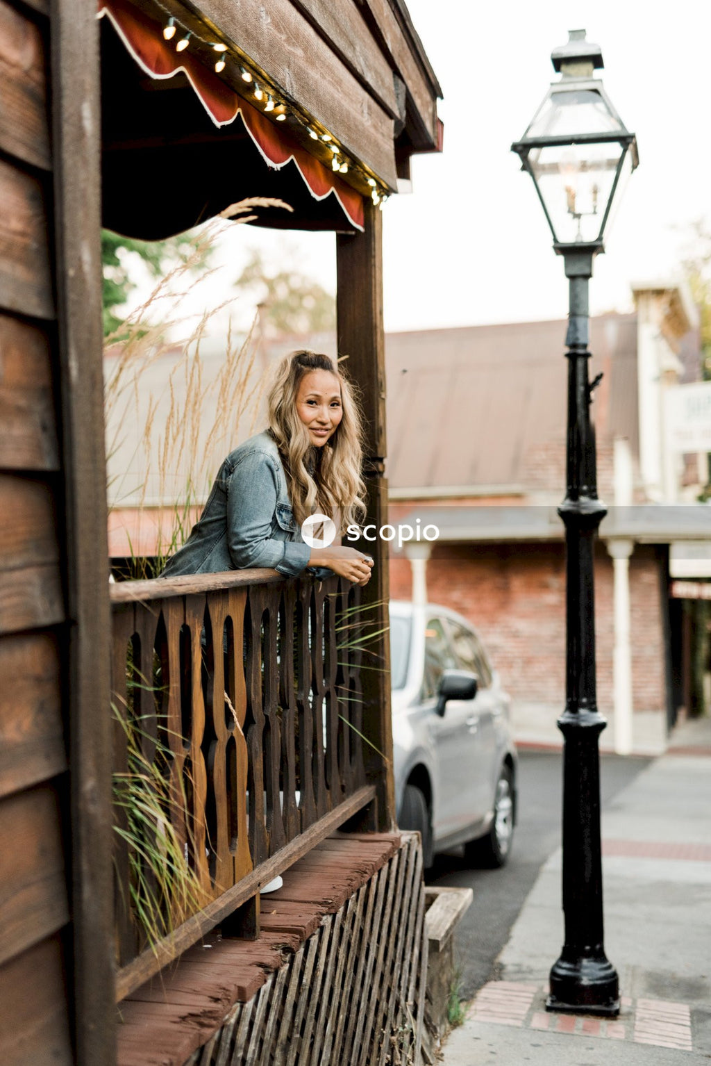 Woman standing at the balcony of her home