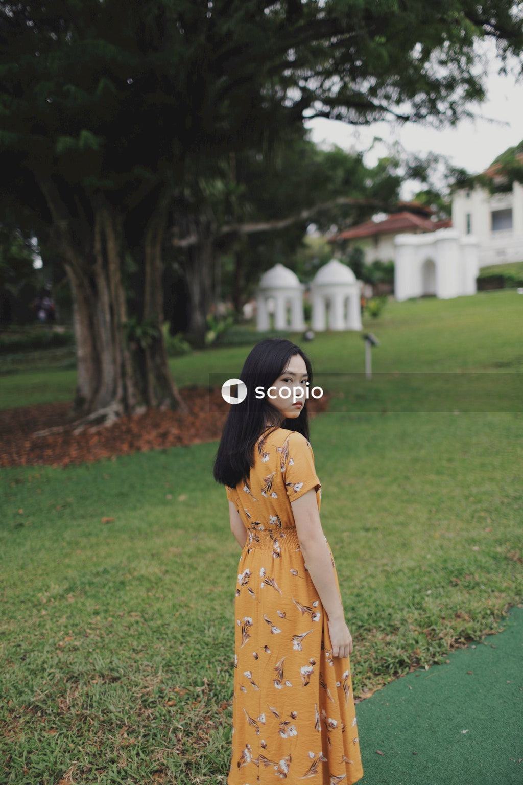 Woman wearing long orange dress standing in nature