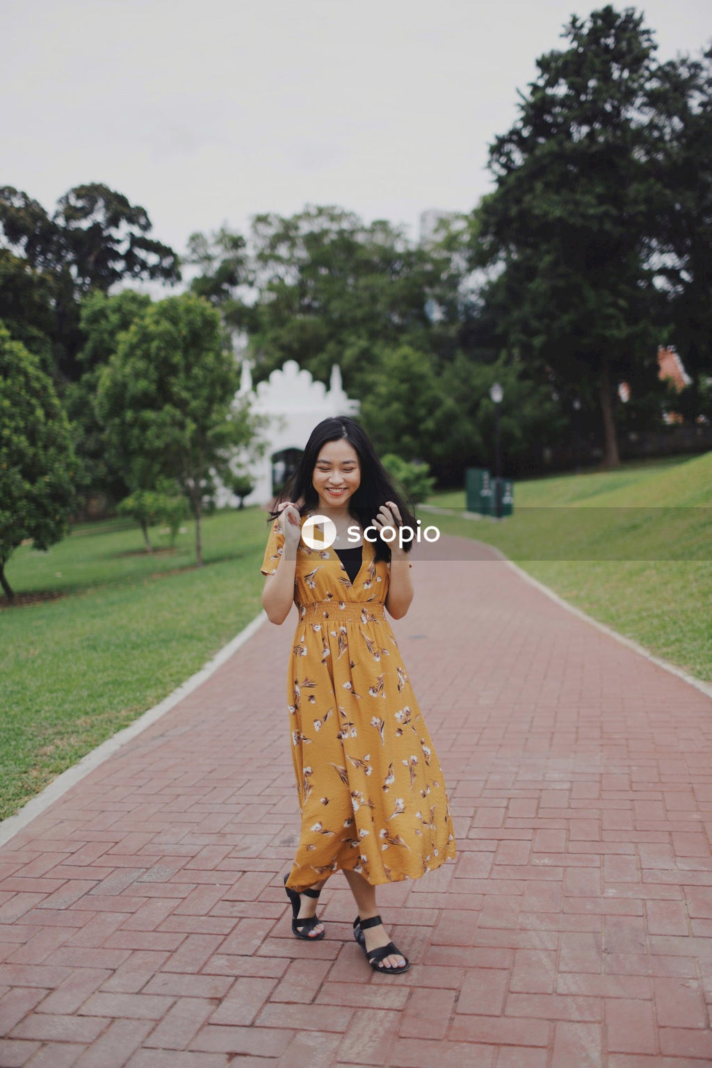 Woman wearing long orange dress standing in nature