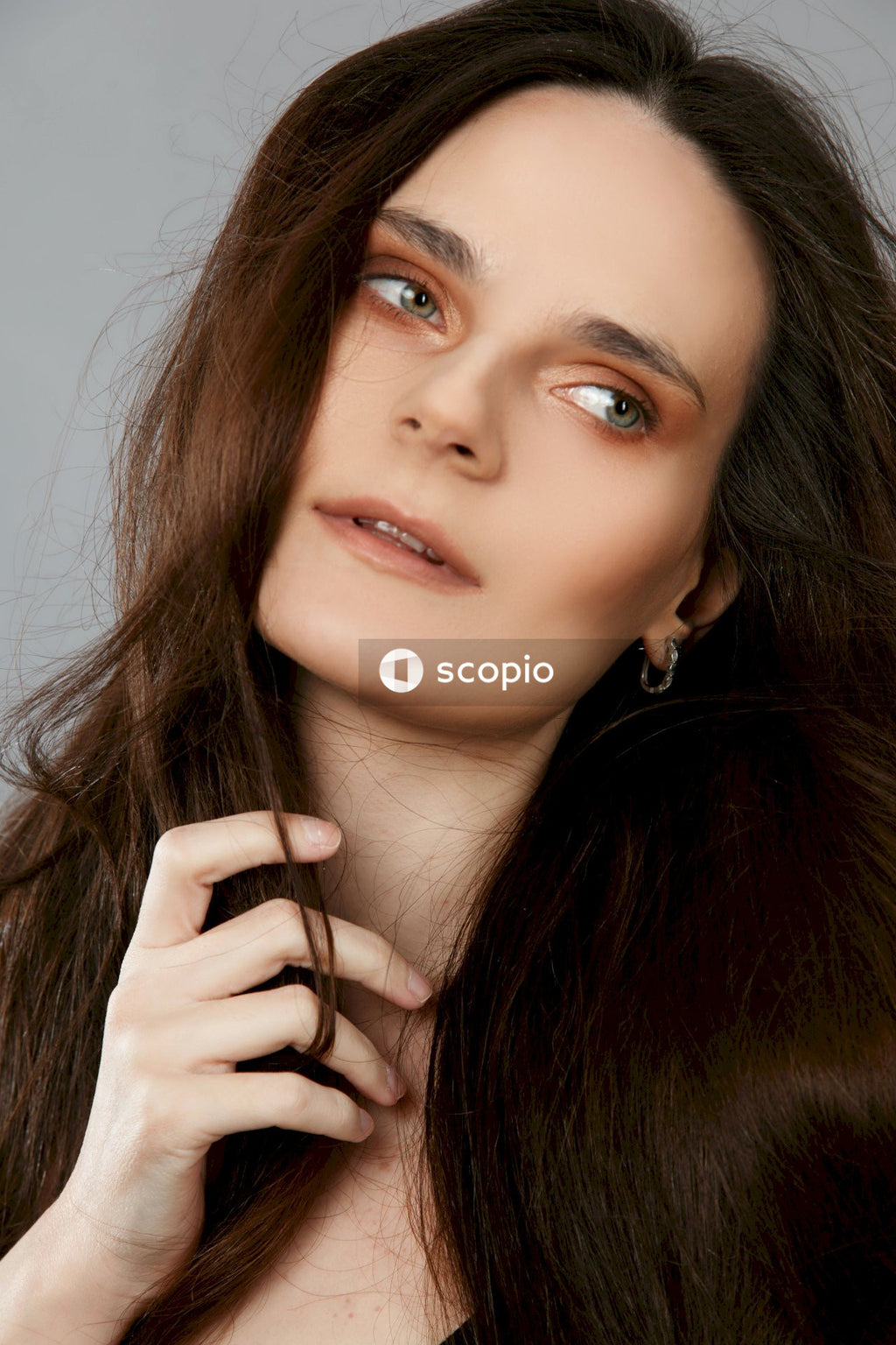 Woman with brown hair covering her face