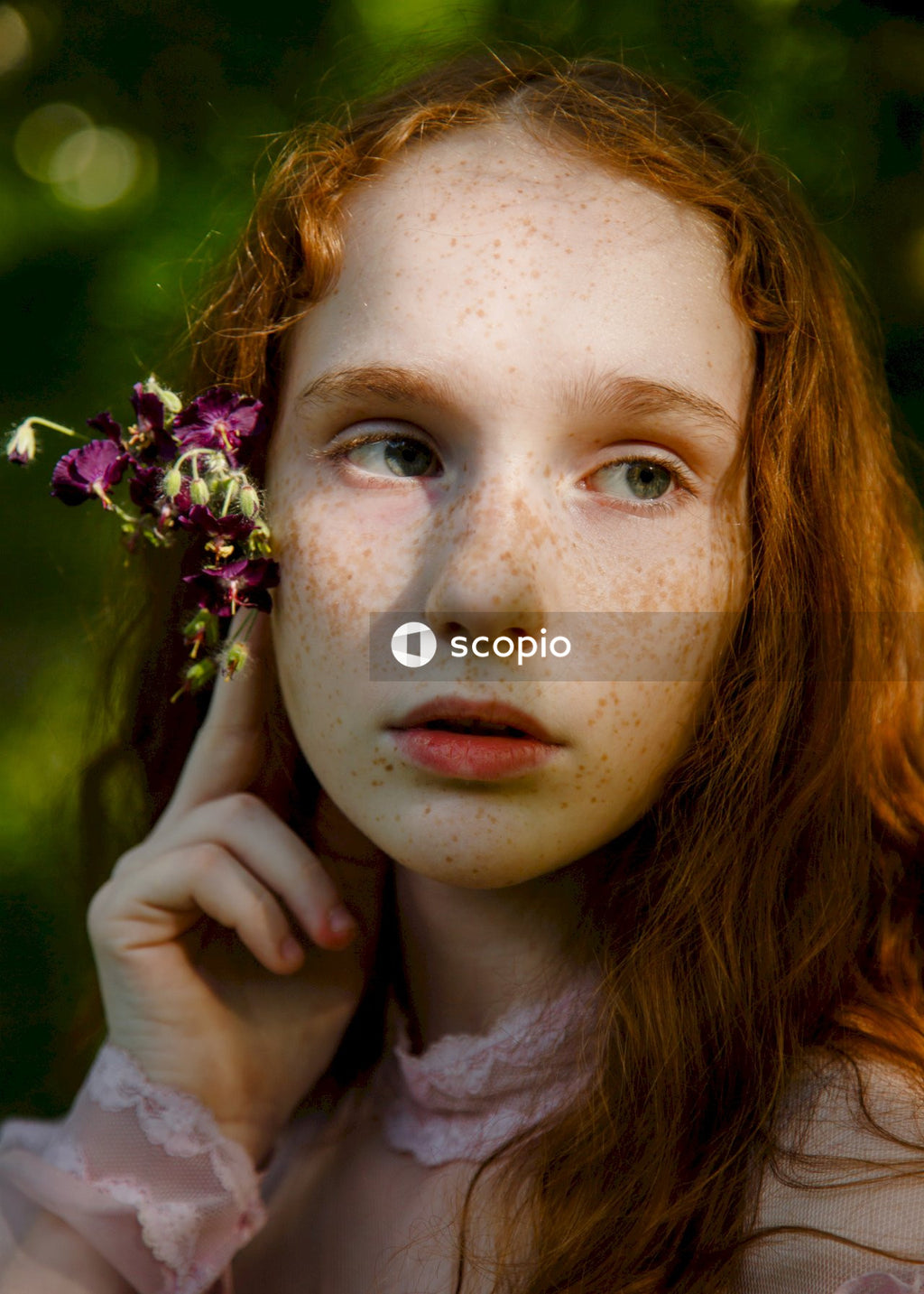 Woman with pink and white flower on her ear