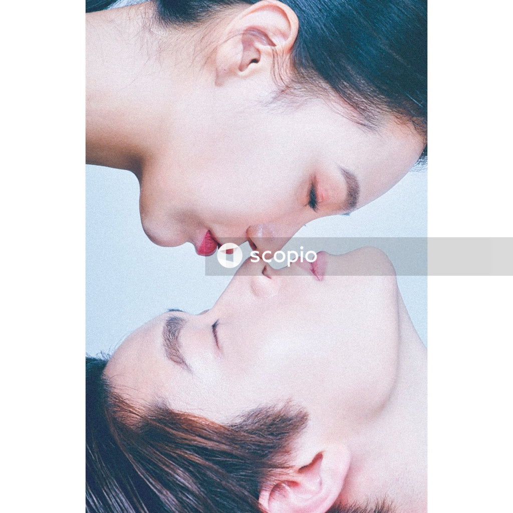 Woman about to kiss a man