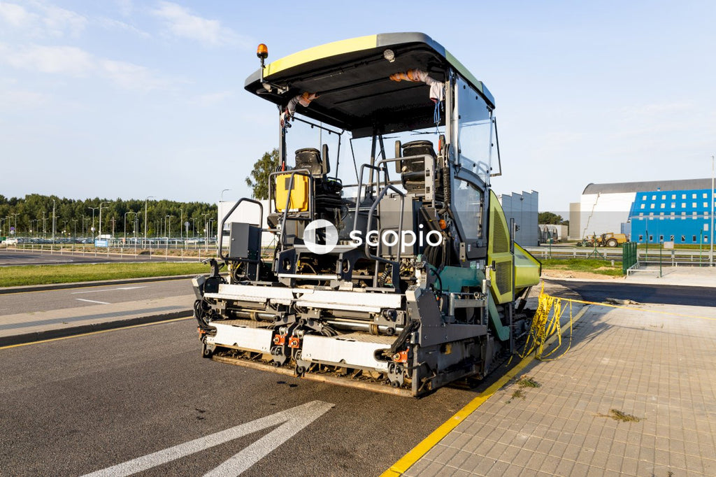 Yellow and green heavy equipment on road